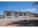 Cozy single-story home featuring a covered outdoor area and desert-friendly landscaping at 1050 Bruce St, Pahrump, NV 89048