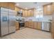 Modern kitchen with stainless steel appliances, white countertops, and wood cabinets at 1050 Bruce St, Pahrump, NV 89048