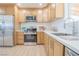 Stylish kitchen features stainless steel appliances, white countertops, and ample wood cabinetry at 1050 Bruce St, Pahrump, NV 89048