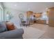 Inviting living area featuring a cozy sofa, dining table, and a kitchen with stainless steel appliances at 1050 Bruce St, Pahrump, NV 89048
