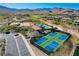 Aerial view of community with pool, tennis courts, lush landscaping and desert mountain views at 11280 Granite Ridge Dr # 1035, Las Vegas, NV 89135
