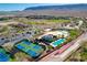Stunning aerial view of community offering tennis courts, pool, landscaping, and mountain backdrops at 11280 Granite Ridge Dr # 1035, Las Vegas, NV 89135