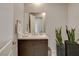 Modern powder room featuring a marble countertop, sleek dark wood cabinets, and contemporary fixtures and decor at 11280 Granite Ridge Dr # 1035, Las Vegas, NV 89135
