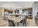 Spacious dining area adjacent to the kitchen features modern lighting and a stylish table with seating at 11280 Granite Ridge Dr # 1035, Las Vegas, NV 89135