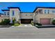 Modern two-story townhome with stone accents, car port, and well-maintained landscaping under a blue sky at 11280 Granite Ridge Dr # 1035, Las Vegas, NV 89135