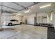 Bright garage featuring a car, cabinets, workspace and overhead lighting at 11280 Granite Ridge Dr # 1035, Las Vegas, NV 89135