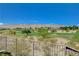 Picturesque golf course view with desert landscape, distant mountain and residential houses under a cloudless sky at 11280 Granite Ridge Dr # 1035, Las Vegas, NV 89135