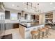 Modern kitchen features a large island with barstool seating, stainless appliances, and stylish pendant lighting at 11280 Granite Ridge Dr # 1035, Las Vegas, NV 89135