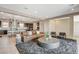 Spacious living room with a leather couch, large round coffee table, and open floor plan to the modern kitchen at 11280 Granite Ridge Dr # 1035, Las Vegas, NV 89135