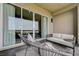 Relaxing outdoor patio features comfortable seating and expansive sliding glass doors to the interior at 11280 Granite Ridge Dr # 1035, Las Vegas, NV 89135