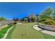 Beautifully landscaped putting green with a modern building and lush plants under a clear blue sky at 11280 Granite Ridge Dr # 1035, Las Vegas, NV 89135