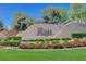 Community sign: The Ridges, surrounded by vibrant flowerbeds, green grass and mature landscaping under a blue sky at 11280 Granite Ridge Dr # 1035, Las Vegas, NV 89135