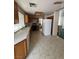 Kitchen with tile floors, wood cabinets, and white appliances at 128 Appian Way, Henderson, NV 89002