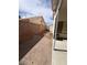 Side yard is graveled and leads to block wall and back yard at 128 Appian Way, Henderson, NV 89002