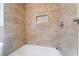 Custom tiled bathroom features tiled shower, white bathtub, and a built-in shower niche at 1356 Spague St, Henderson, NV 89011