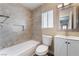 Well-lit bathroom features a shower over tub, a tiled niche, and a modern vanity at 1356 Spague St, Henderson, NV 89011