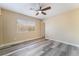 Spacious bedroom with wood-look flooring, a ceiling fan, and large window for natural light at 1356 Spague St, Henderson, NV 89011