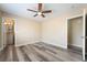 Bright bedroom with ceiling fan and vinyl flooring, adjoining bathroom, offering modern comfort at 1356 Spague St, Henderson, NV 89011