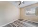 Cozy bedroom with a ceiling fan, a window, and wood-look laminate flooring at 1356 Spague St, Henderson, NV 89011