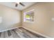 Cozy bedroom with wood-look flooring, a ceiling fan, and a bright window at 1356 Spague St, Henderson, NV 89011