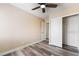 Bedroom with a ceiling fan, closet with sliding doors and wood-look laminate flooring at 1356 Spague St, Henderson, NV 89011