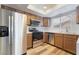 Modern kitchen featuring stainless steel appliances, ample countertop space, and wood-look flooring at 1356 Spague St, Henderson, NV 89011