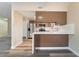 Open kitchen layout featuring sleek countertops, new appliances, and an island with seating at 1356 Spague St, Henderson, NV 89011