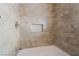 Close up of a tiled shower-over-tub with a tiled niche for storage at 1356 Spague St, Henderson, NV 89011