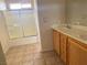 Bright bathroom with double sink vanity, mirror, tile floor and shower with glass doors at 1434 Summer Glow Ave, Henderson, NV 89012