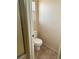 Enclosed toilet area next to a shower with glass doors and neutral tile flooring at 1434 Summer Glow Ave, Henderson, NV 89012