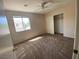 Bright bedroom features a ceiling fan, closet, and window with neighborhood views at 1434 Summer Glow Ave, Henderson, NV 89012