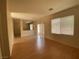 Bright living room with neutral paint, wood-style floors, and large windows providing natural light at 1434 Summer Glow Ave, Henderson, NV 89012