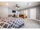Bedroom with TV, bedside table, adjacent bathroom, dresser, and gray walls at 1521 Sombrero Dr, Las Vegas, NV 89169