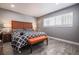 Well-lit bedroom features wood-look floors and a modern bedframe with an orange bench at 1521 Sombrero Dr, Las Vegas, NV 89169
