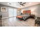Bedroom featuring a bed, chair, bedside tables with lamps, art and gray walls at 1521 Sombrero Dr, Las Vegas, NV 89169