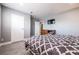 Bedroom with TV, bedside table, dresser, and gray walls at 1521 Sombrero Dr, Las Vegas, NV 89169