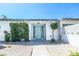 Charming home exterior with a decorative security gate and lush green bushes adding to its curb appeal at 1521 Sombrero Dr, Las Vegas, NV 89169
