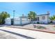 Charming home with white fence, decorative rock landscaping, and a lion design, adding unique curb appeal at 1521 Sombrero Dr, Las Vegas, NV 89169