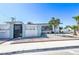 Inviting home featuring a decorative white fence, desert landscaping, and a neatly maintained front yard at 1521 Sombrero Dr, Las Vegas, NV 89169