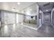 Hallway with mirrored wall and gray walls, wood flooring and white doors at 1521 Sombrero Dr, Las Vegas, NV 89169