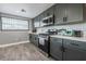 Bright kitchen with gray cabinets, stainless steel appliances, and ample counter space at 1521 Sombrero Dr, Las Vegas, NV 89169