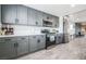 Updated kitchen featuring gray cabinets, stainless steel appliances, and wood-look floors at 1521 Sombrero Dr, Las Vegas, NV 89169