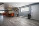 Open concept dining and living area with wood-look floors and large windows at 1521 Sombrero Dr, Las Vegas, NV 89169
