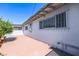 Brick patio running along the side of the home with window bars and a shady corner at 1521 Sombrero Dr, Las Vegas, NV 89169