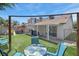 This backyard features artificial turf, a covered patio, and outdoor seating at 1622 Lorna Dr, Henderson, NV 89011