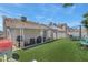 Artificial turf, covered patio, and play area highlight this backyard at 1622 Lorna Dr, Henderson, NV 89011