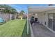 A beautiful backyard features green lawn, patio, and a play area at 1622 Lorna Dr, Henderson, NV 89011