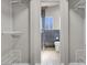 Walk-in closet leads to remodeled bathroom with dark tile and floating vanity at 1622 Lorna Dr, Henderson, NV 89011