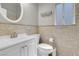 Bathroom featuring neutral tiled walls, a white vanity, and modern fixtures at 1622 Lorna Dr, Henderson, NV 89011