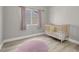 Neutral Bedroom featuring light wood floors, a pink rug, and bright natural light at 1622 Lorna Dr, Henderson, NV 89011